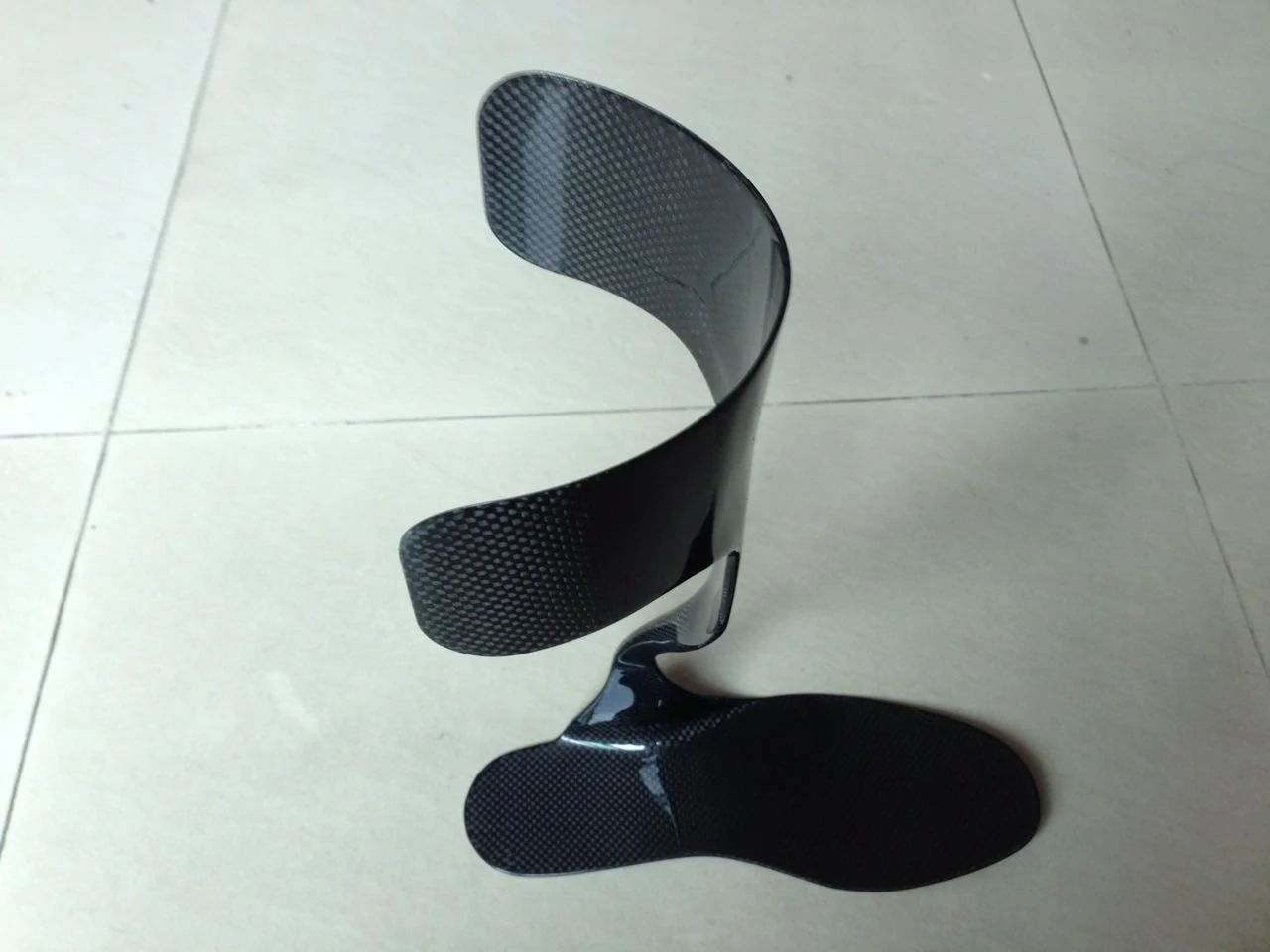 Photograph of a custom-shaped carbon fiber component